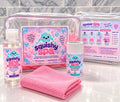 Squishy Spa kit with labeled soap and dust containers, a pink cloth and clear carry bags.